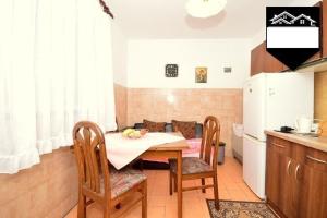 a kitchen with a table and chairs in a room at Apartment Jelka in Herceg-Novi +4 photos