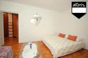 a bedroom with two beds and a table in it at Apartment Jelka in Herceg-Novi