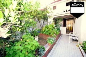 a garden with plants and a table and chairs at Apartment Jelka in Herceg-Novi