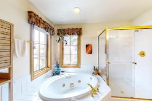 a bathroom with a tub and a shower at Ski Den #22 in Copper Mountain