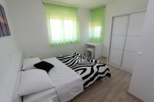 Postel nebo postele na pokoji v ubytování Villa Tamarut