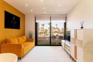 a living room with a couch and a table at The best apartament in Orihuela Costa