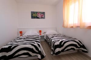 Postel nebo postele na pokoji v ubytování Villa Tamarut