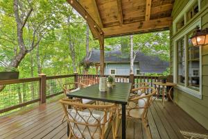 a porch with a table and chairs on a deck at Cashiers Getaway with Decks and Golf Course Views in Cashiers
