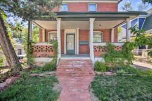 a brick house with a brick pathway leading to the front door at Fresh Downtown Longmont Apartment - Walk to Main! in Longmont