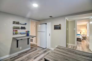 a kitchen with a counter and a refrigerator in a room at Fresh Downtown Longmont Apartment - Walk to Main! in Longmont