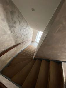 a spiral staircase in a building with a window at Gîte des Vosges in Anould