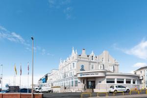 a white building with cars parked in front of it at Best Western Carlton Hotel in Blackpool