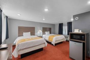 a hotel room with two beds and a television at Budget Lodge in Ruidoso +31 photos