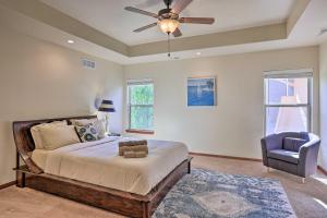 a bedroom with a bed and a ceiling fan and a chair at Spacious Omaha Home with Expansive Yard and Patio in Omaha