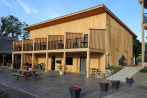 a large wooden building with a picnic table and benches at Lakeside Resort in Watkins Glen