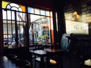 a restaurant with a table and chairs in front of a window at ViaVia Buenos Aires GuestHouse in Buenos Aires