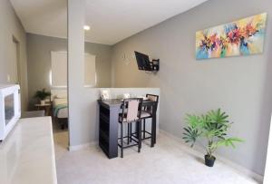 a living room with a table and a painting on the wall at 8th Street Suites in Cozumel