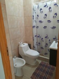 a bathroom with a toilet and a shower curtain at TU REFUGIO - Alquiler Temporario in Santiago del Estero
