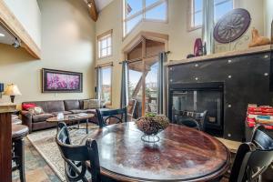 a living room with a table and a fireplace at Dillon Ridge Retreat in Dillon