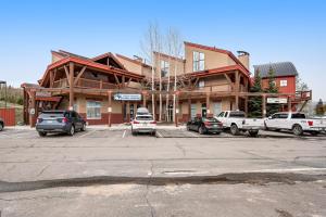 a parking lot with cars parked in front of a building at Dillon Ridge Retreat in Dillon