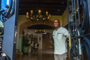 a man standing in the doorway of a building at Hotel Capellán de Getsemaní in Cartagena de Indias