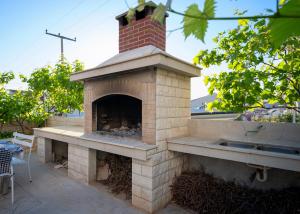 a brick oven with a brick chimney on a patio at Villa Fio - Rooms & Studio in Hvar