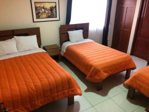 Rúm í herbergi á Tambo Cusco Inn