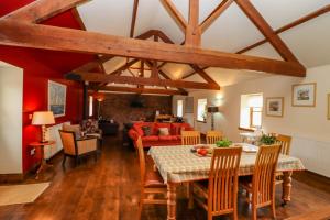 a dining room and living room with a table and chairs at Cartwheels Cottage in Great Driffield