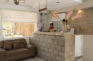 two people standing at a counter in a room at El Gamonal - Paracas in Paracas