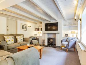 a living room with a couch and a fireplace at 3 Rose Cottages in St. Agnes 