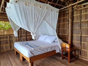 Ένα ή περισσότερα κρεβάτια σε δωμάτιο στο Wai Resort - Raja Ampat