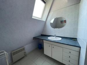 a bathroom with a sink and a mirror at Villa 5 pièces avec jardin, à 400m de la plage et 600m des commerces, wifi et barbecue inclus - FR-1-361-20 in Jullouville-les-Pins +25 photos