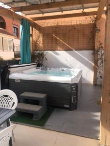 a hot tub sitting in an outdoor patio at Beautiful Five bedroom three bathroom entire Villa in Málaga