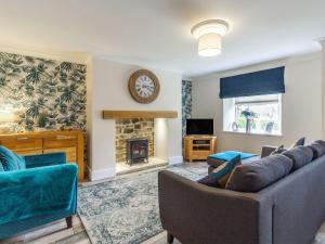 a living room with a couch and a fireplace at Seabreeze Cottage in Ashington