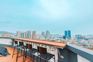 a group of chairs sitting on top of a roof at Big K House in Busan