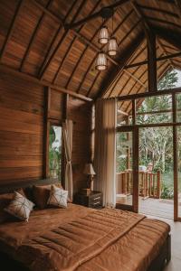 a bedroom with a large bed in a house at Kusfarm Bali by AHM in Selemadeg +54 photos