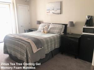 a teddy bear sitting on a bed in a bedroom at Tempe ASU Guest Suite in Tempe