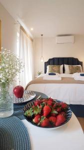 a room with a bowl of strawberries on a table at Sole e Luna Studio · Corfu Old Town in Corfu