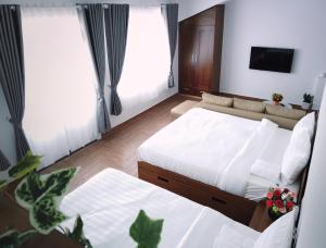 Postel nebo postele na pokoji v ubytování Free Style Hotel Dalat