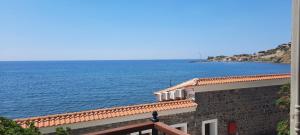 a view of the ocean from a building at Olive Press Hotel & Apartments in Mythimna