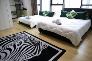 two beds in a room with a zebra rug at Jungle Loft for 6-7pax near IKEA, Kidzania and 1U in Petaling Jaya
