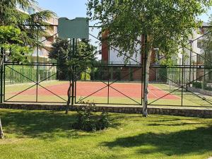 einen Tennisplatz mit Bäumen und einem Zaun in der Unterkunft Fort Knox Privilege C-4 265 Apartment in Sweti Wlas