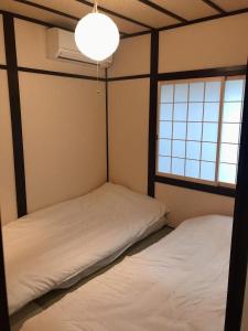 Posteľ alebo postele v izbe v ubytovaní WUMETEI Japanese-style lodge