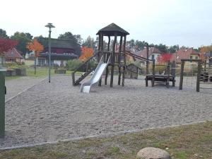a playground with a slide in a park at Weißes Traumhaus in Glowe
