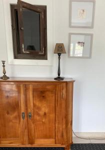 a dresser with a mirror and a lamp on it at Mosel - River - Quartier 31 in Lieser