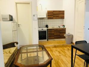 a living room with a table and a kitchen at A1 Stay Apartments in Copenhagen