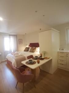 a bedroom with a bed and a table and a desk at Sole e Luna Studio · Corfu Old Town in Corfu