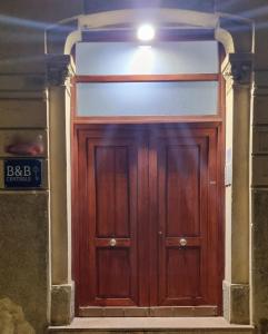 a wooden door in the middle of a building at B&B CENTRALE in Messina
