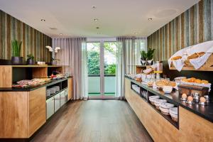 a kitchen with a buffet of food on display at City Appartementhotel in Bad Füssing