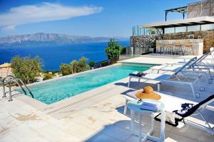 a swimming pool with a view of the water at Stone Crafted Luxury Villas in Nikiana