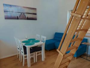 a dining room with a table and a blue couch at Ahoj Siemiany in Siemiany