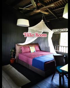 a bed in a room with a sign that reads villa room at Harrera Perhentian, Long Beach in Perhentian Island