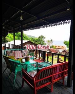 a patio with a table and chairs on a deck at Harrera Perhentian, Long Beach in Perhentian Island