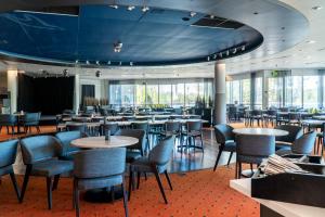 a large dining room with tables and chairs at Spa Hotel Kunnonpaikka in Kuopio
